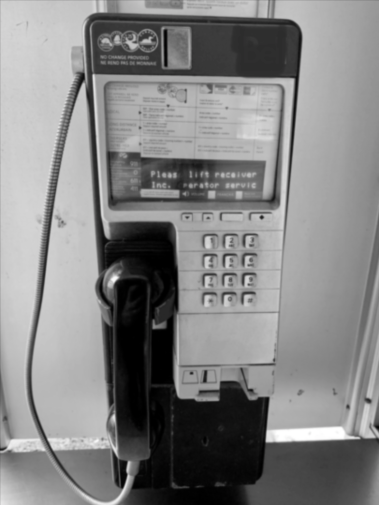 Image of a payphone in greyscale